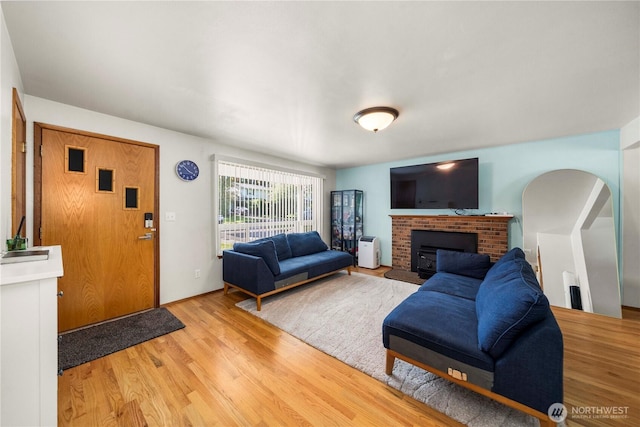 28624 27th Pl S, Federal Way, WA 98003 - living area featuring light wood-style floors, a brick fireplace, and arched walkways