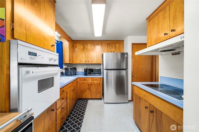 28624 27th Pl S, Federal Way, WA 98003 - kitchen with stainless steel appliances, under cabinet range hood, brown cabinets, and light flooring