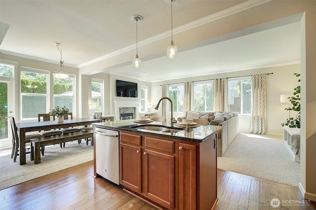 24817 SE 13th Pl, Sammamish, WA 98075 - kitchen featuring a sink, stainless steel dishwasher, open floor plan, a fireplace, and brown cabinetry