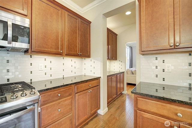 24817 SE 13th Pl, Sammamish, WA 98075 - kitchen featuring stainless steel appliances, ornamental molding, light wood finished floors, dark stone countertops, and backsplash