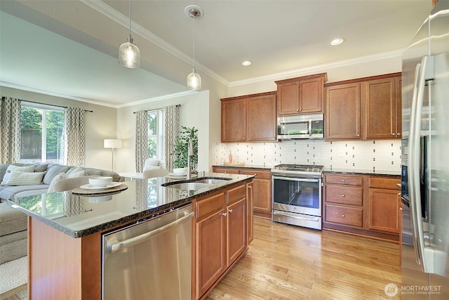 24817 SE 13th Pl, Sammamish, WA 98075 - kitchen with appliances with stainless steel finishes, a sink, open floor plan, brown cabinets, and crown molding