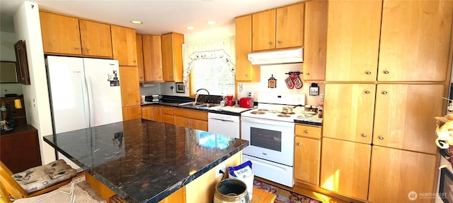 324 Pond Ln, Sequim, WA 98382 - kitchen with under cabinet range hood, white appliances, a sink, recessed lighting, and a center island