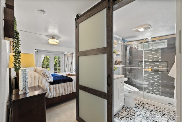31707 W Lake Ketchum Rd, Stanwood, WA 98292 - ensuite bathroom with toilet, french doors, a stall shower, tile patterned floors, and vanity