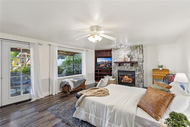 31707 W Lake Ketchum Rd, Stanwood, WA 98292 - bedroom with wood finished floors, access to outside, a fireplace, rail lighting, and ceiling fan