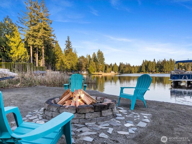 31707 W Lake Ketchum Rd, Stanwood, WA 98292 - view of patio / terrace featuring a fire pit, a water view, and a wooded view