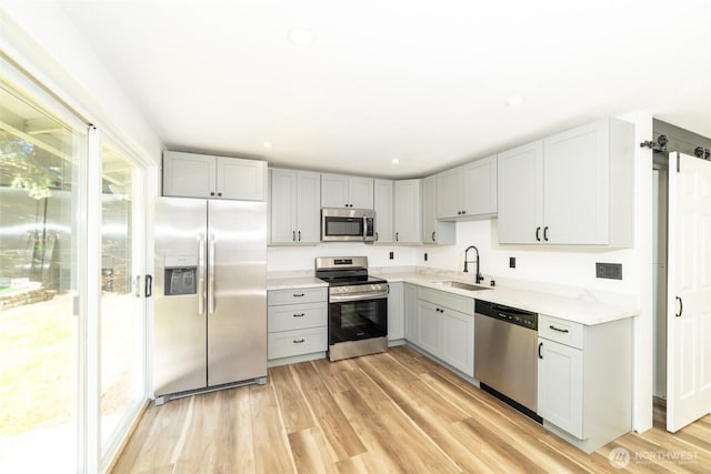 15310 25th St E, Tacoma, WA 98445 - kitchen featuring stainless steel appliances, a sink, healthy amount of natural light, gray cabinets, and recessed lighting