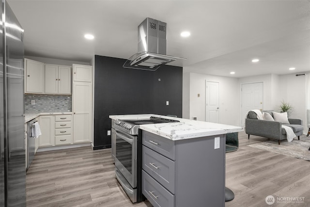 8517 188th Ct E, Puyallup, WA 98375 - kitchen featuring stainless steel appliances, island exhaust hood, a center island, gray cabinets, and light stone counters