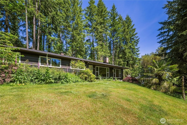 4006 147th Pl SE, Bellevue, WA 98006 - back of house with a yard and a chimney