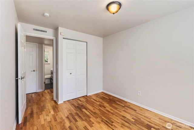 4006 147th Pl SE, Bellevue, WA 98006 - unfurnished bedroom featuring light wood-style floors, a closet, and baseboards