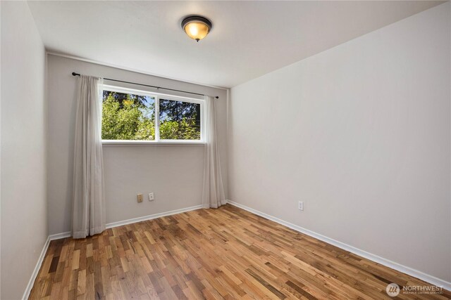 4006 147th Pl SE, Bellevue, WA 98006 - empty room featuring wood finished floors and baseboards