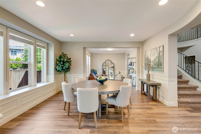 3623 148th St SE, Mill Creek, WA 98012 - dining room featuring a decorative wall, wainscoting, recessed lighting, stairway, and light wood finished floors
