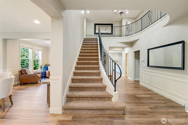 3623 148th St SE, Mill Creek, WA 98012 - stairway featuring wood finished floors, a chandelier, a decorative wall, and recessed lighting