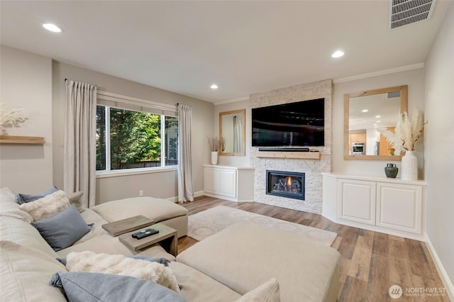 3623 148th St SE, Mill Creek, WA 98012 - living area with wood finished floors, a stone fireplace, recessed lighting, baseboards, and crown molding
