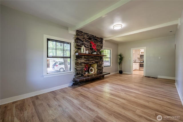 18005 Burn Rd, Arlington, WA 98223 - unfurnished living room with light wood finished floors, beam ceiling, and a stone fireplace
