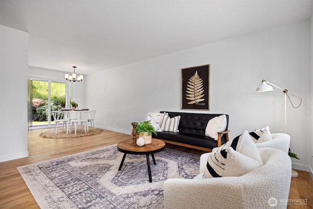 4243 Wintergreen Cir Unit 136, Bellingham, WA 98226 - living room featuring a chandelier, wood finished floors, and baseboards