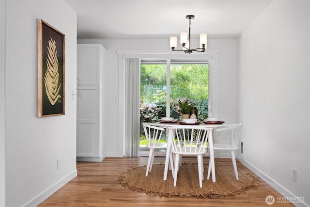 4243 Wintergreen Cir Unit 136, Bellingham, WA 98226 - dining space featuring a chandelier, baseboards, and light wood-style flooring