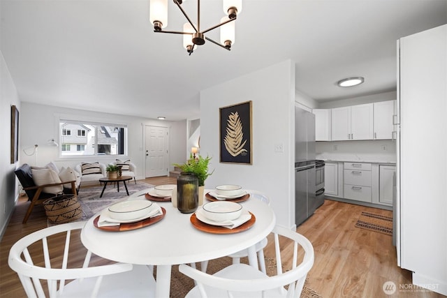 4243 Wintergreen Cir Unit 136, Bellingham, WA 98226 - dining area featuring a chandelier and light wood-style flooring