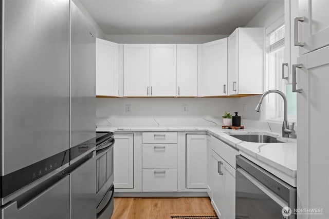 4243 Wintergreen Cir Unit 136, Bellingham, WA 98226 - kitchen featuring stainless steel appliances, light stone counters, and white cabinetry