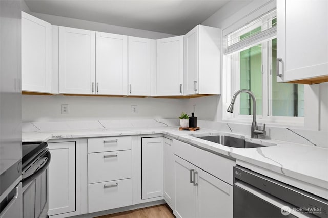 4243 Wintergreen Cir Unit 136, Bellingham, WA 98226 - kitchen with black electric range oven, stainless steel dishwasher, a sink, white cabinets, and light stone counters