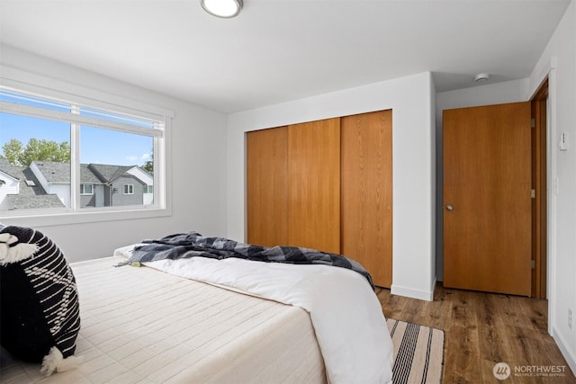 4243 Wintergreen Cir Unit 136, Bellingham, WA 98226 - bedroom featuring a closet, wood finished floors, and baseboards