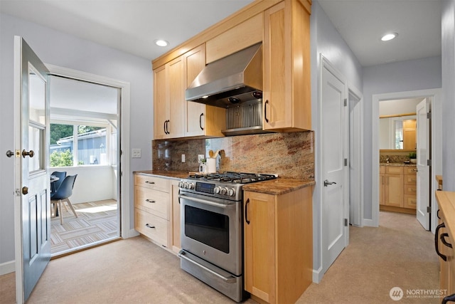 2921 Ellis St, Bellingham, WA 98225 - kitchen with gas stove, extractor fan, light brown cabinetry, tasteful backsplash, and stone counters