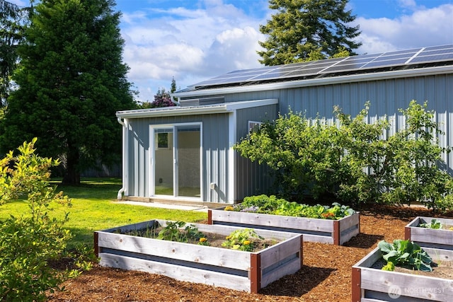 2921 Ellis St, Bellingham, WA 98225 - back of house featuring a vegetable garden, a lawn, and solar panels
