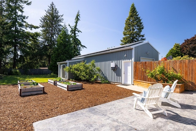 2921 Ellis St, Bellingham, WA 98225 - fenced backyard with a vegetable garden and a patio