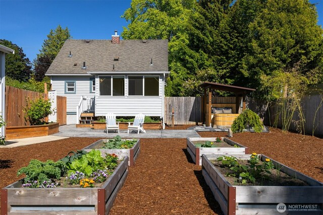 2921 Ellis St, Bellingham, WA 98225 - back of house with a garden, a shingled roof, and a chimney