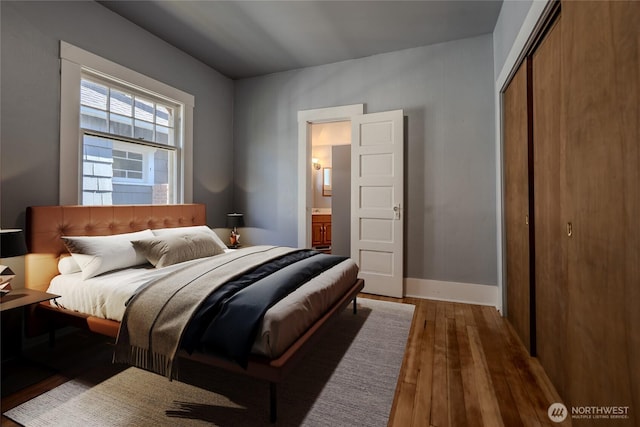914 N Cedar St, Tacoma, WA 98406 - bedroom featuring hardwood / wood-style floors, a closet, and baseboards