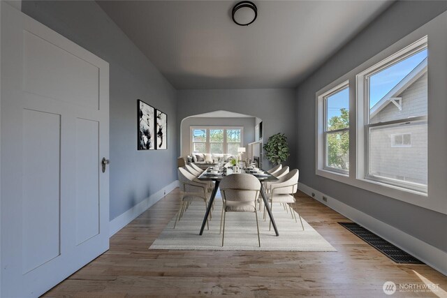 914 N Cedar St, Tacoma, WA 98406 - dining space featuring arched walkways, wood finished floors, and baseboards