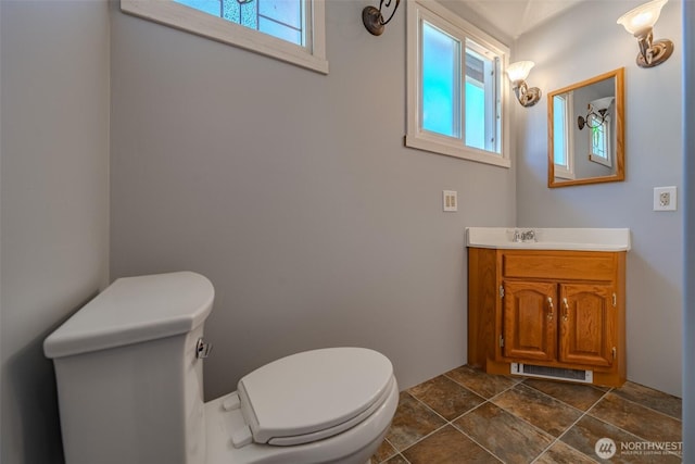 914 N Cedar St, Tacoma, WA 98406 - half bathroom with toilet, healthy amount of natural light, vanity, and stone finish floors
