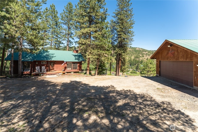 5721 Mountain Lane Rd, Peshastin, WA 98847 - view of property exterior with metal roof, a detached garage, a mountain view, and an outdoor structure