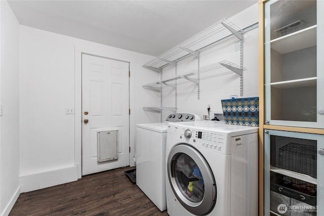 5721 Mountain Lane Rd, Peshastin, WA 98847 - washroom with washer and clothes dryer and dark wood-style floors