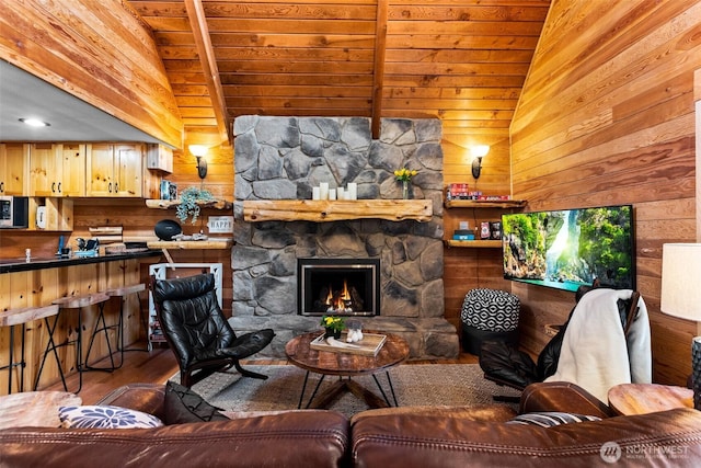 44019 Fir Rd, Gold Bar, WA 98251 - living area with wooden walls, vaulted ceiling, wood finished floors, wood ceiling, and a fireplace