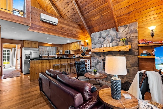 44019 Fir Rd, Gold Bar, WA 98251 - living room with a wall mounted AC, wooden ceiling with exposed beams, wooden walls, wood finished floors, and high vaulted ceiling