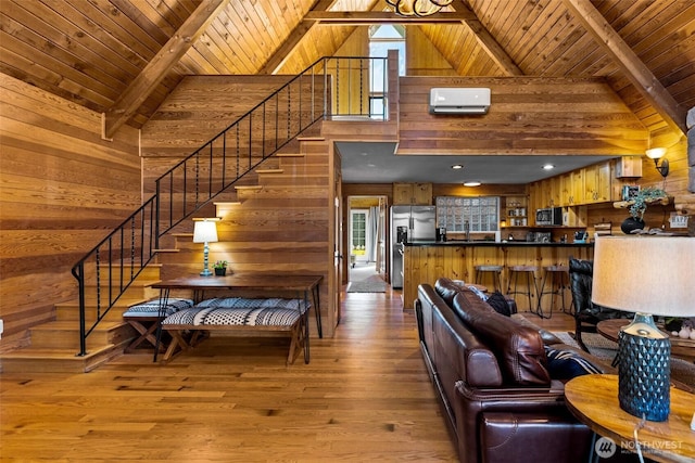 44019 Fir Rd, Gold Bar, WA 98251 - living area with wood walls, wooden ceiling with exposed beams, healthy amount of natural light, stairs, and high vaulted ceiling