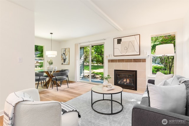 9805 Avondale Rd NE Unit M139, Redmond, WA 98052 - living room with wood finished floors, plenty of natural light, beam ceiling, and a fireplace