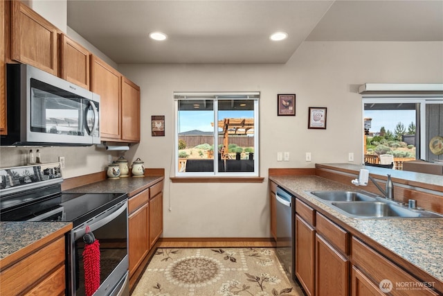 894 Desert Aire Dr SW, Mattawa, WA 99349 - kitchen featuring stainless steel appliances, a sink, brown cabinetry, baseboards, and recessed lighting