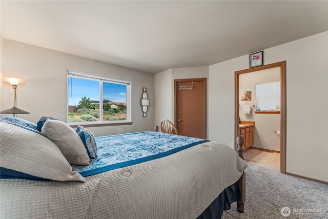 894 Desert Aire Dr SW, Mattawa, WA 99349 - bedroom featuring light carpet, baseboards, and ensuite bath