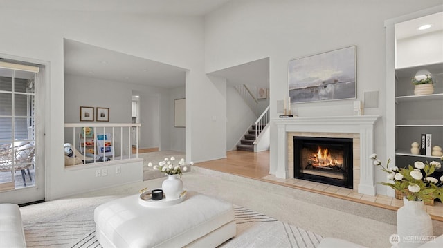 11405 SE 65th St, Bellevue, WA 98006 - carpeted living room featuring a tile fireplace, stairway, recessed lighting, built in features, and baseboards