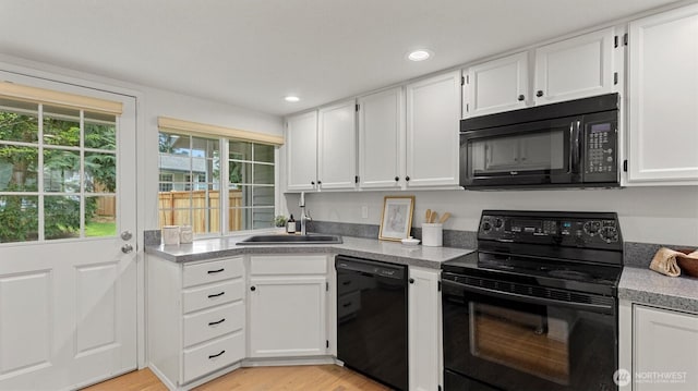 11405 SE 65th St, Bellevue, WA 98006 - kitchen with black appliances, a sink, white cabinetry, light wood-style floors, and recessed lighting