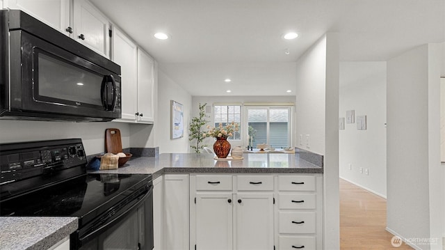 11405 SE 65th St, Bellevue, WA 98006 - kitchen featuring black appliances, white cabinetry, light wood-style floors, and recessed lighting