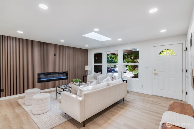 30156 2nd Pl SW, Federal Way, WA 98023 - living room featuring a glass covered fireplace, light wood-style floors, a skylight, recessed lighting, and baseboards