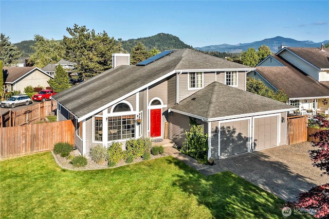 404 Jewell St, Enumclaw, WA 98022 - traditional home featuring roof mounted solar panels, a mountain view, roof with shingles, a chimney, and a garage