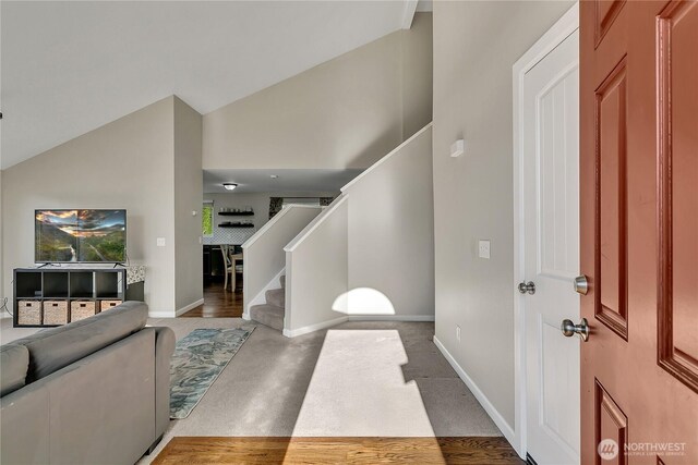 404 Jewell St, Enumclaw, WA 98022 - foyer featuring stairway, baseboards, high vaulted ceiling, and wood finished floors