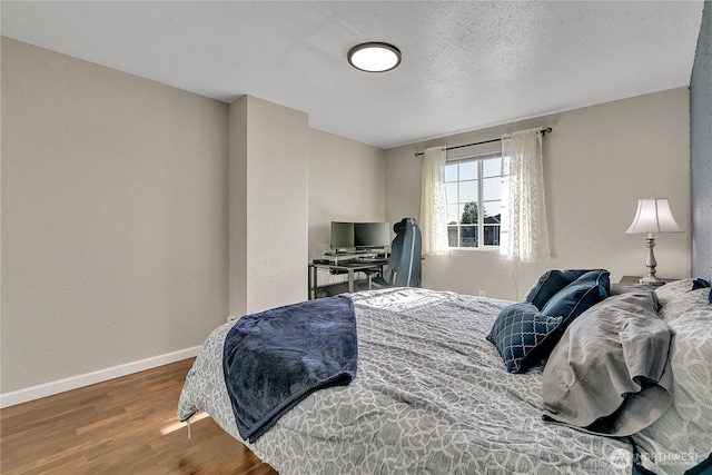 404 Jewell St, Enumclaw, WA 98022 - bedroom featuring wood finished floors, baseboards, and a desk