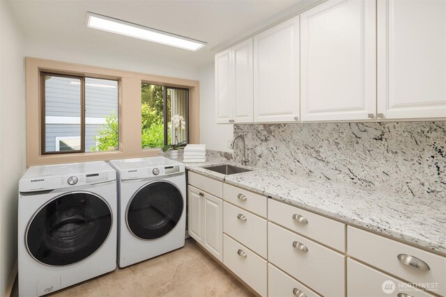 10250 SE 21st St, Bellevue, WA 98004 - laundry room featuring washer and clothes dryer, cabinet space, and light tile patterned flooring
