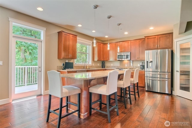 20208 81st Pl NE, Kenmore, WA 98028 - kitchen featuring appliances with stainless steel finishes, a center island, dark wood-type flooring, a kitchen breakfast bar, and recessed lighting