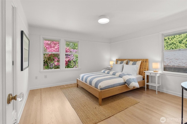 1536 NW 100th St, Seattle, WA 98177 - bedroom featuring wood finished floors, multiple windows, and baseboards