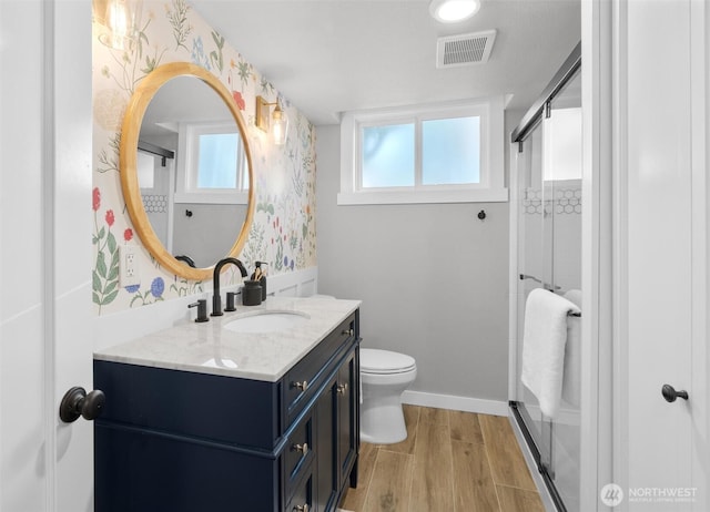 1536 NW 100th St, Seattle, WA 98177 - bathroom featuring wallpapered walls, vanity, a stall shower, toilet, and wood finished floors